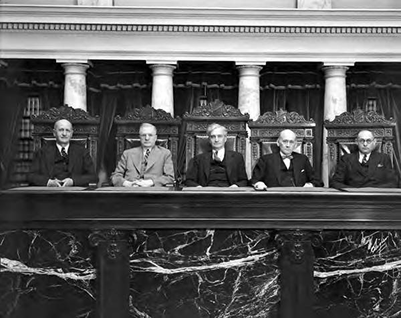 Idaho Supreme Court justices photographed in 1937. The courtroom shown here is now the budget hearing room for the Idaho Legislature.